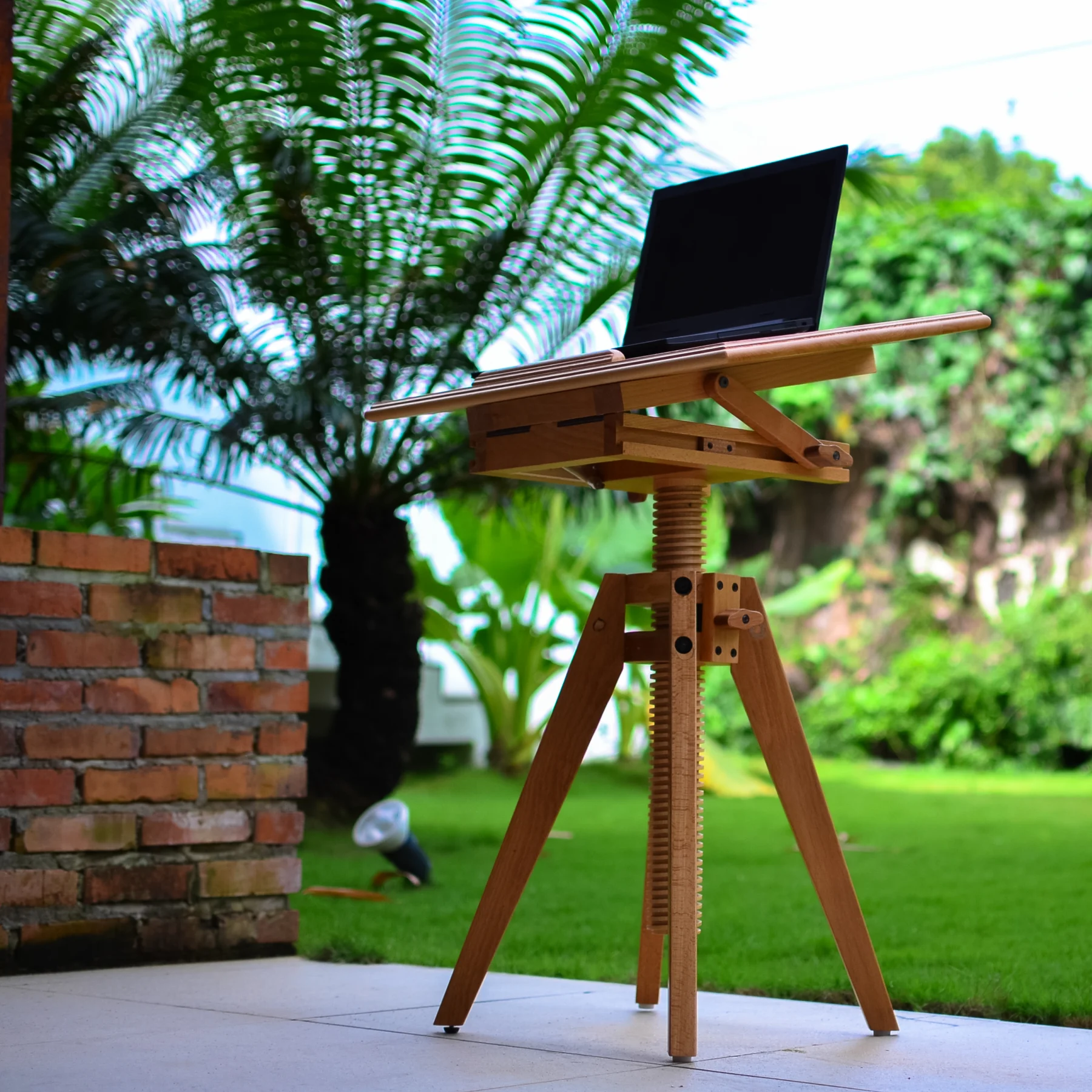 FlexHeight adjustable wood desk with a laptop in an outdoor setting